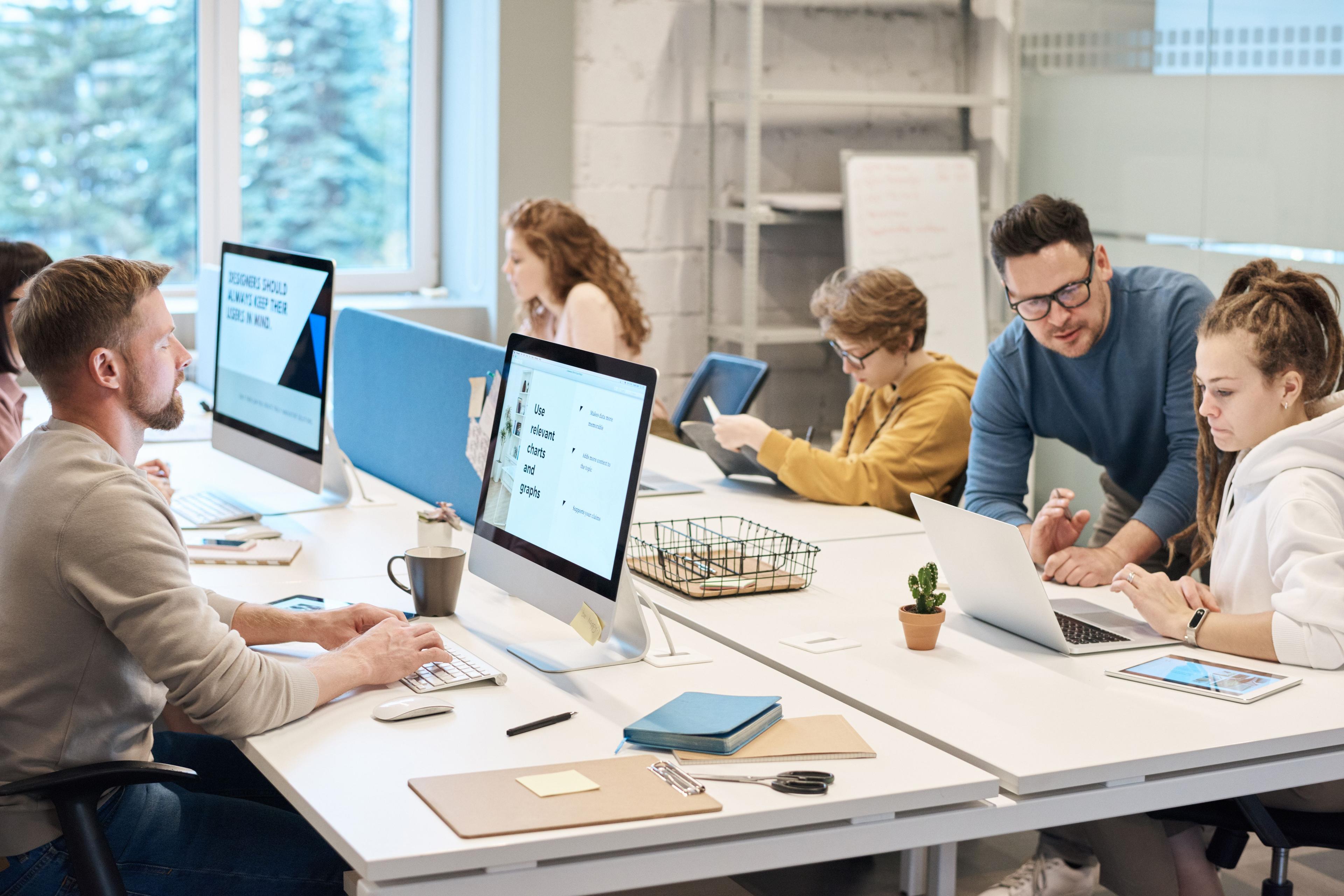 A digital marketing analyst reviewing campaign data across two monitors